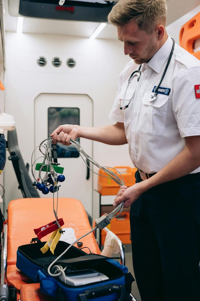 Paramedic organizing equipment in ambulance, showcasing emergency medical services.